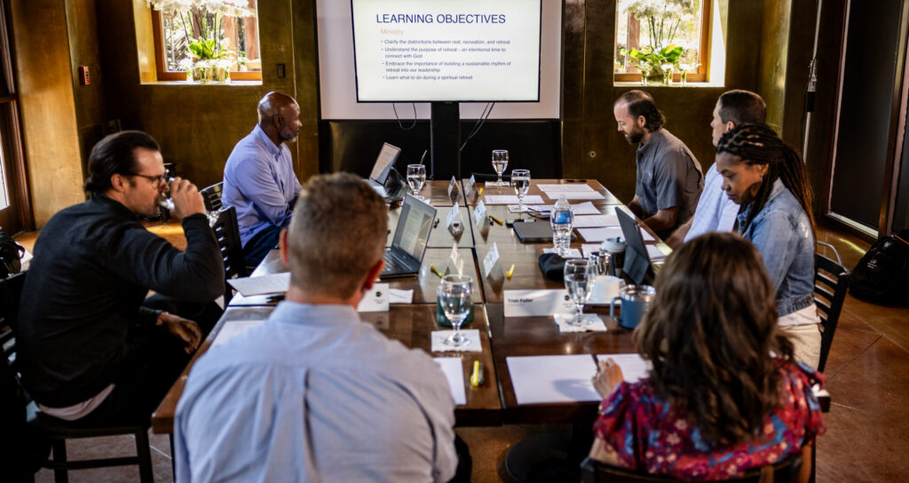 group of C12 members around a table during their Forum experience