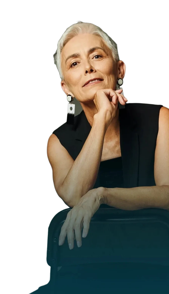 older woman posing for a photo with her hand under her chin